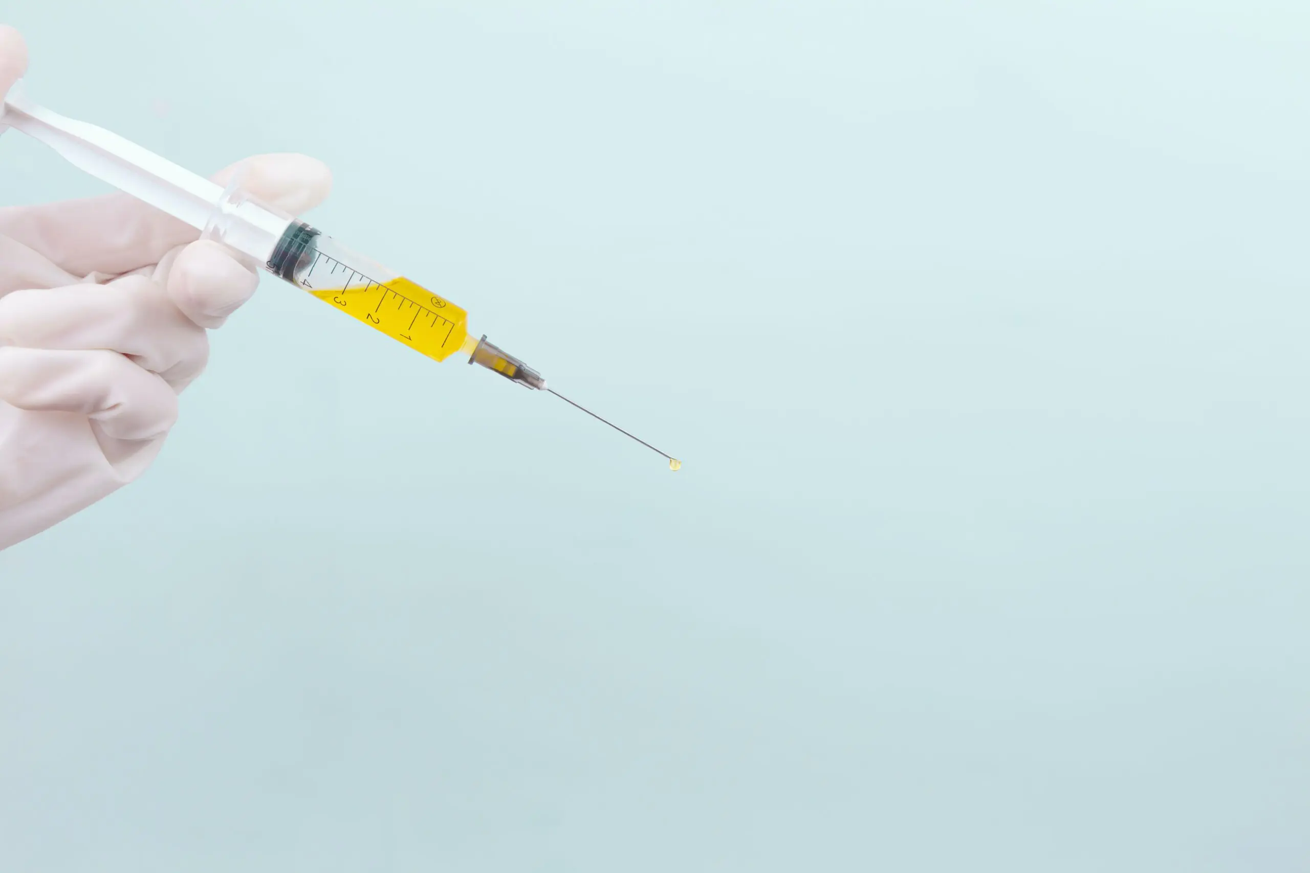 Doctor holding syringe with micrografting serum