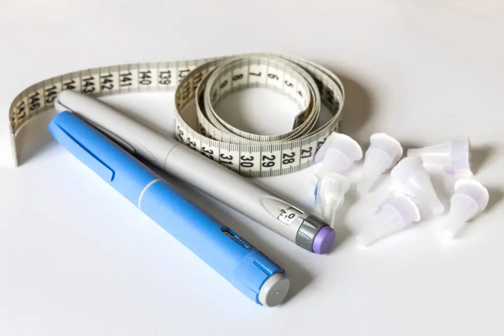 A measuring tape and Ozempic injection.