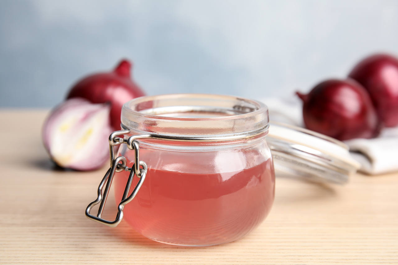 fresh onion juice for a hair treatment in a glass jar