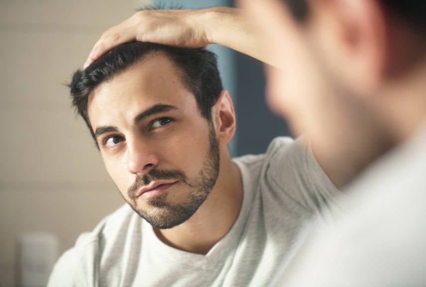 man worried about his receding hairline