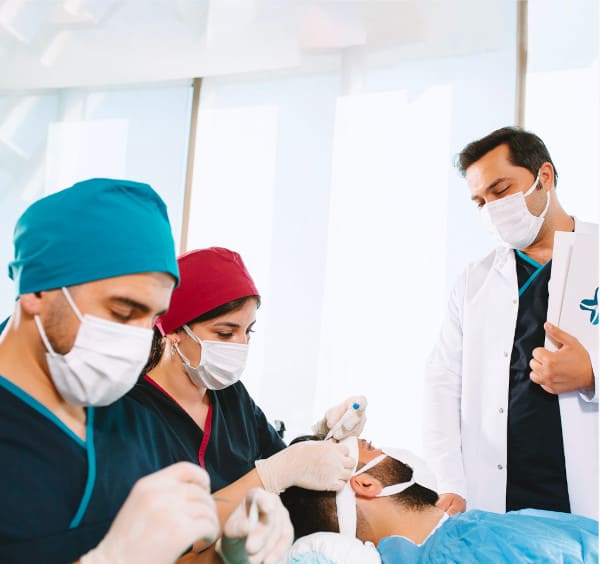 Dr Balwi and his team during a DHI hair transplantation