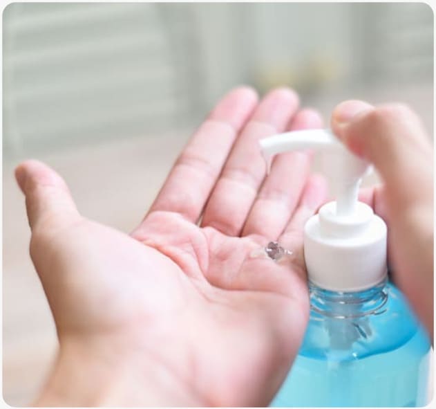 dispensing hand sanitiser gel into the palm of their hand