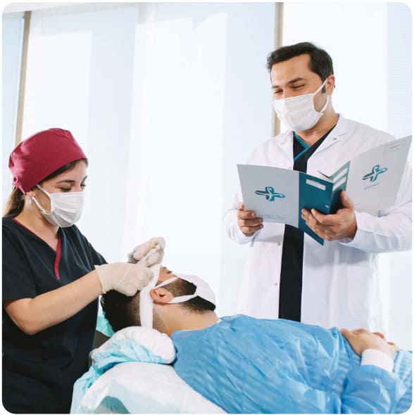 dr balwi with a member of the elithair team and a patient