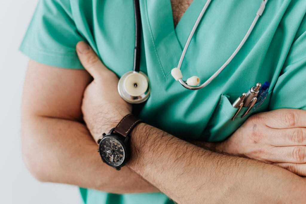 Doctor with hands crossed in scrubs