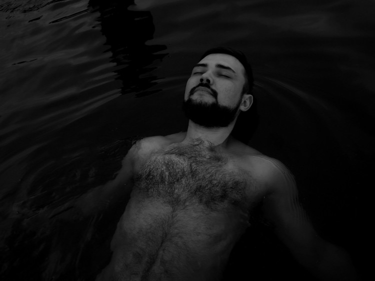 Image of a man in water showing chest hair