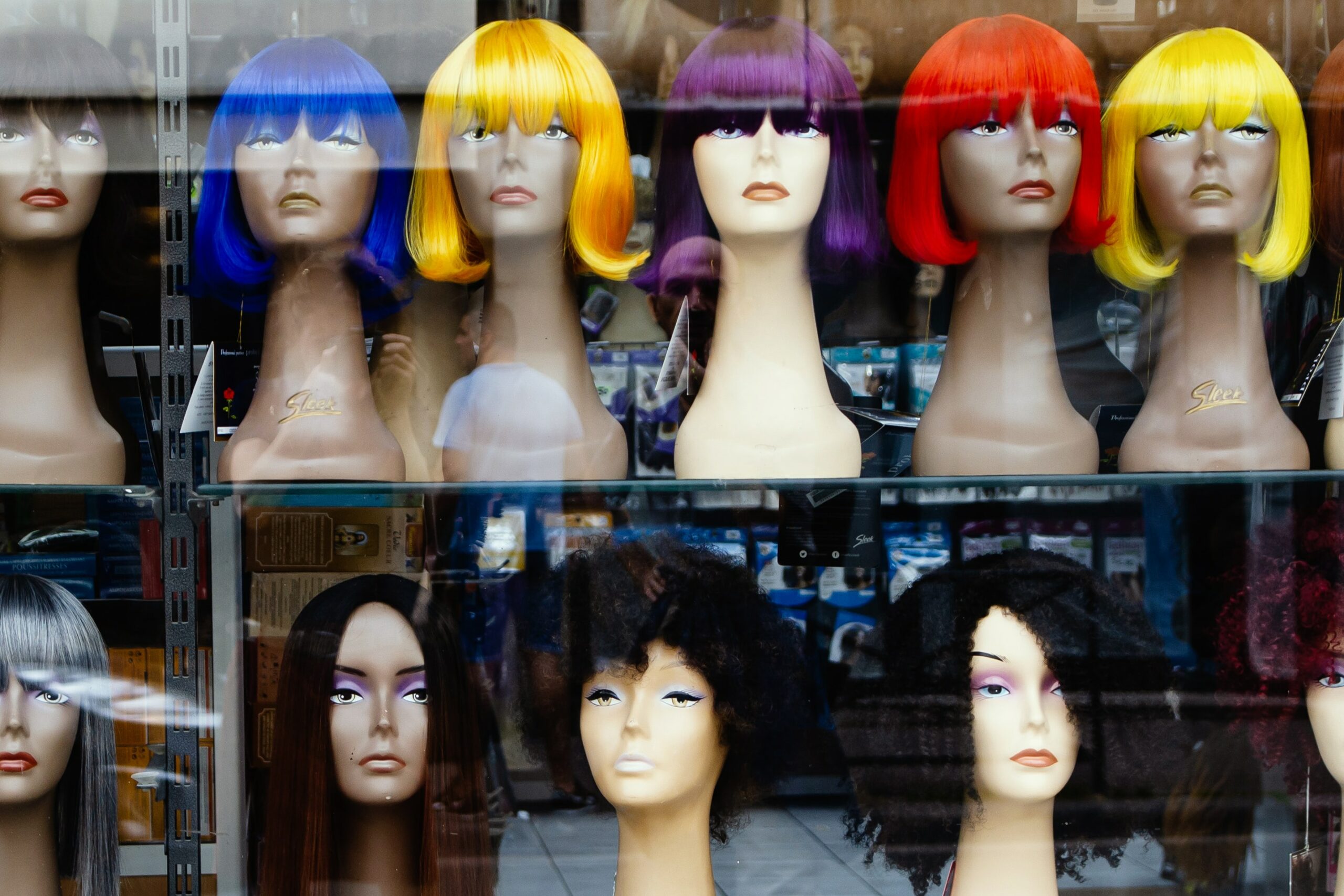 Image of wigs in a shop window