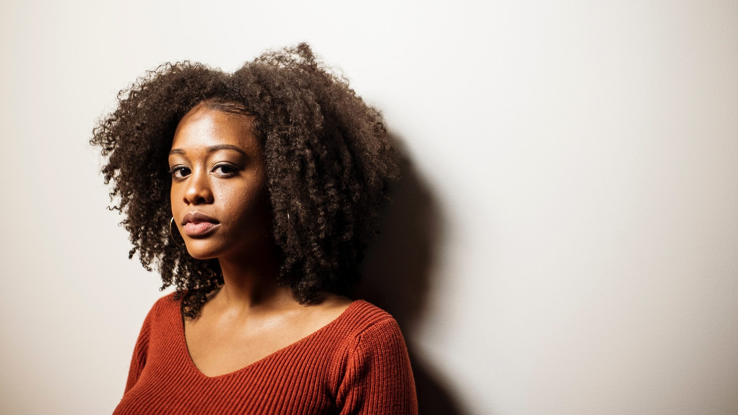 Woman with afro hair looking toward camera