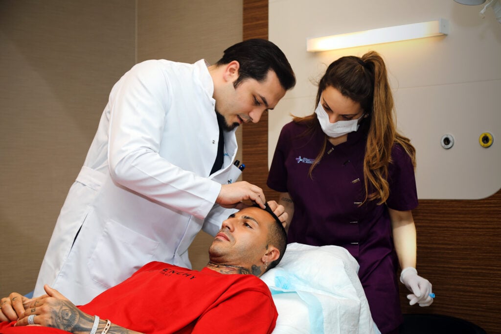 Dr Balwi consulting with patient along with a nurse