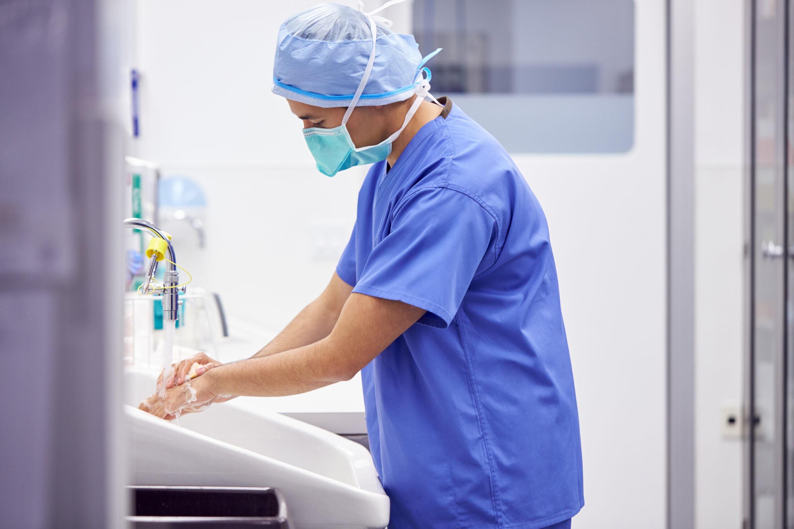 Surgeon washing his hands before artificial hair transplant surgery