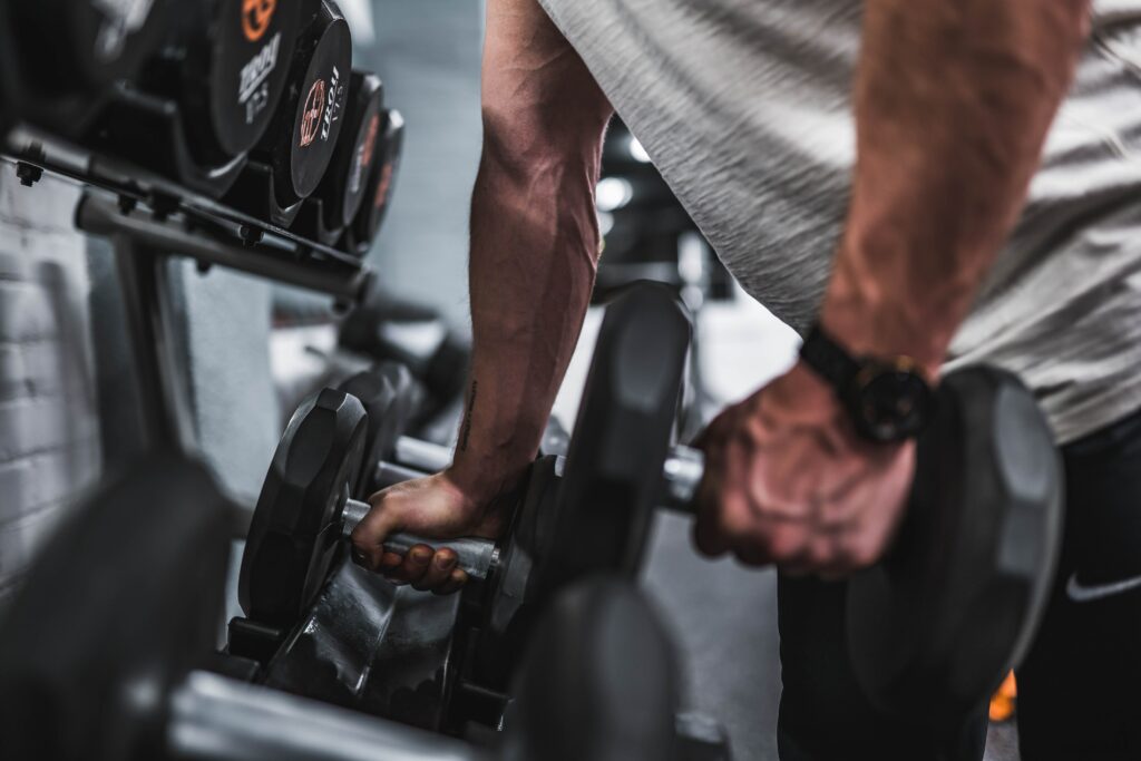 man lifting weights in gym