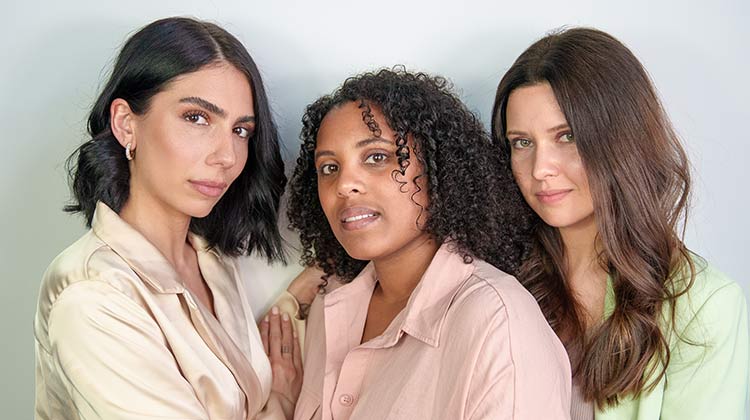 Three female patients posing after their PRP hair treatment