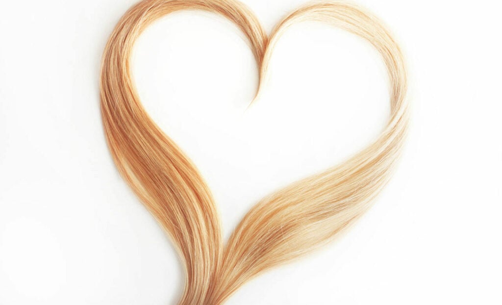 Two locks of blonde hair twisted into the shape of a heart.