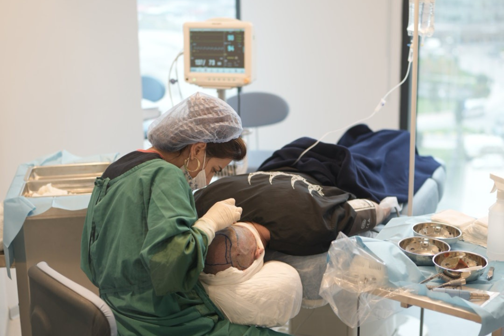 An Elithair medical staffer operates on a sedated patient.