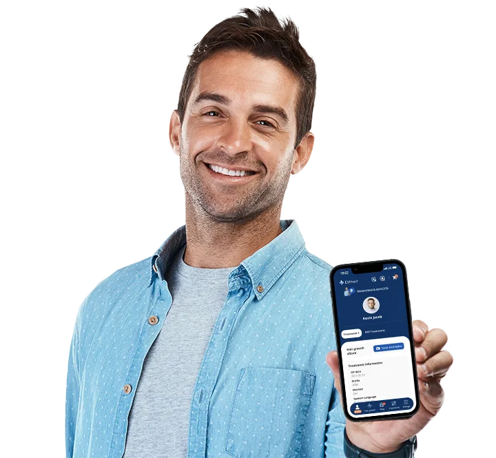 Elithair patient smiling while showing the Elithair app on his phone