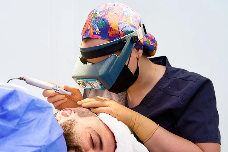 A patient undergoing follicle extraction for a hair transplant.