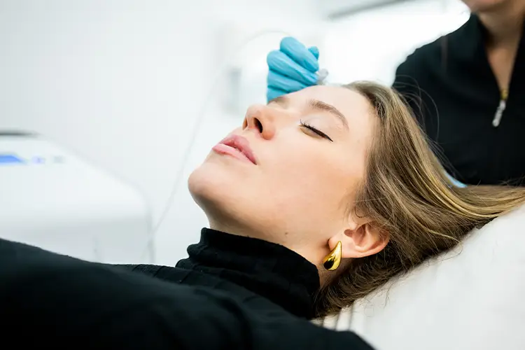 A woman receiving topical oxygen therapy for hair loss.
