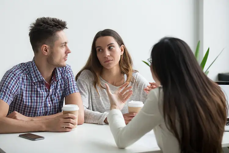 A couple attend a counselling session.