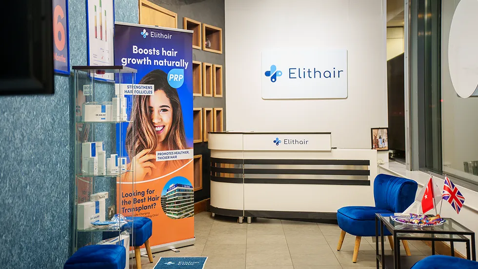Elithair clinic reception with PRP banner, blue chairs, and product display
