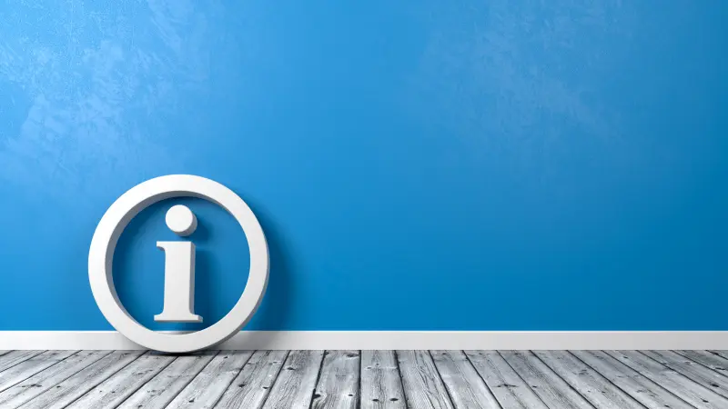 A white information symbol in a circle leaning against a blue background