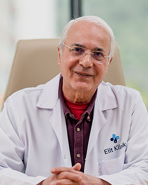 Doctor Ömer Alp, cosmetic surgeon at Elithair, smiling warmly while seated in a bright medical office.