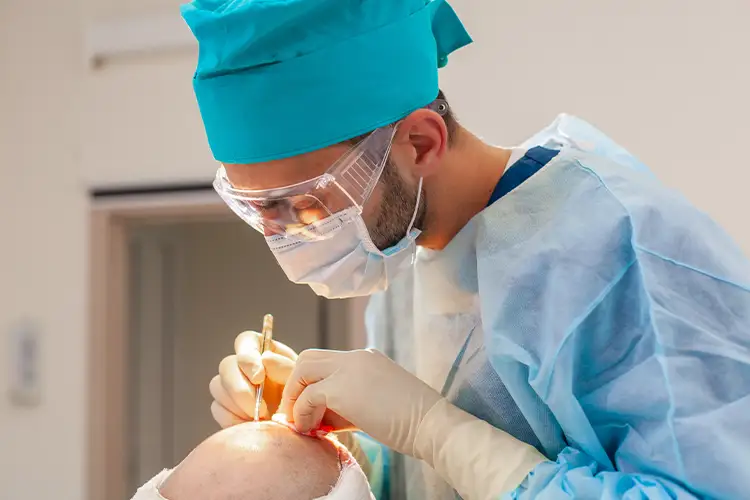 A medical staff member performing a hair transplant.