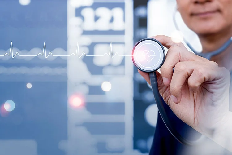 A doctor holds up a stethoscope. An illustration of a heart monitor overlays the image.