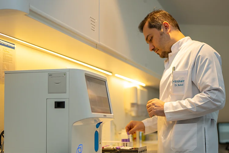 Elithair medical director, Dr. Balwi, working in the research lab.