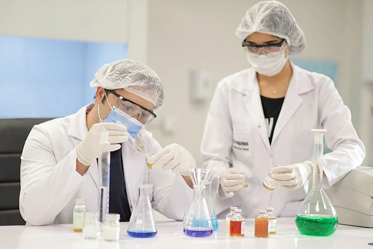 Dr. Balwi and another member of the Elithair medical staff work together in a lab.