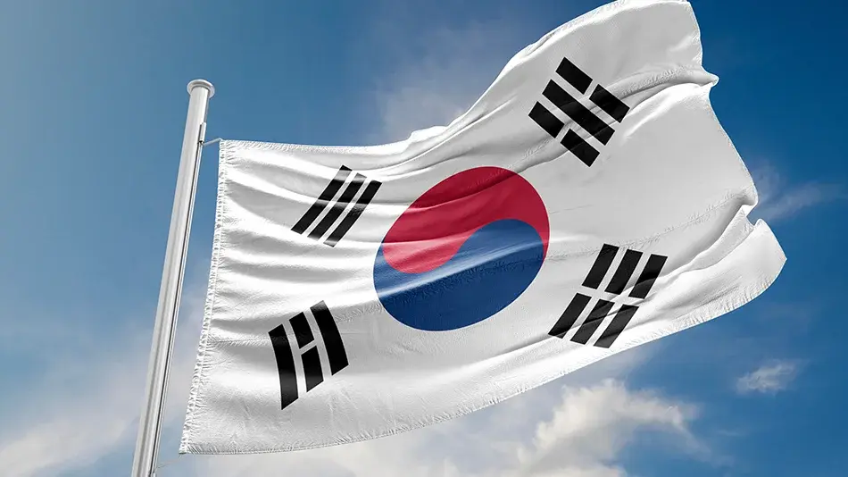 The South Korean flag flying against a blue sky.